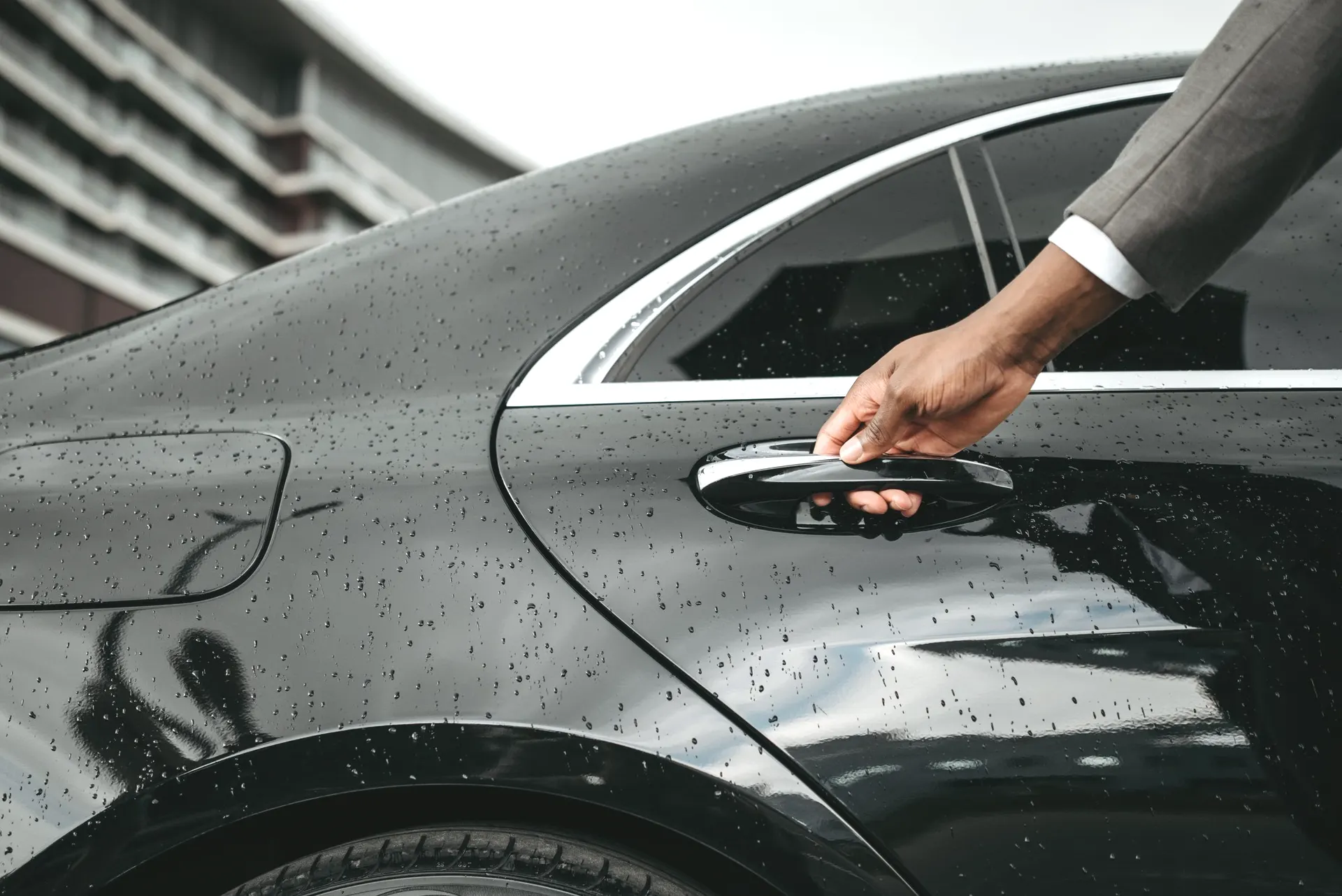 A hand opening a car door